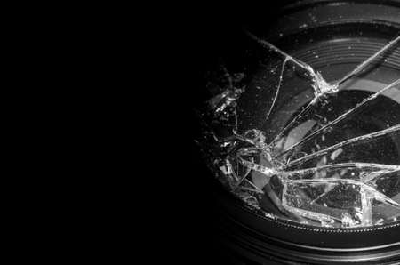 Broken DSLR camera lens on black backgroundの写真素材