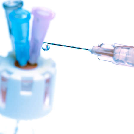 medical tool, syringe squirting fluid, isolated on whiteの写真素材