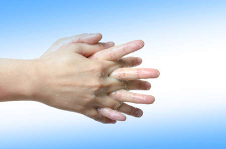medical wash hand gesture series, cleaning with bubble on blue backgroundの写真素材
