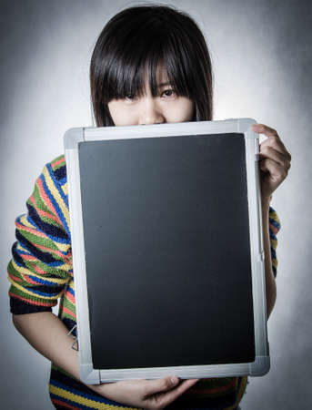 asian woman with blackboard isolated on whiteの写真素材