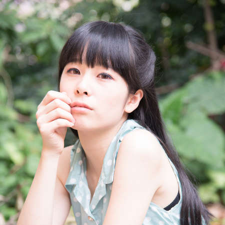 Asian Chinese girl in outdoor gardenの写真素材