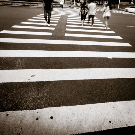 people crowd rush to modern city building on zebra crossing street, blur abstractの写真素材