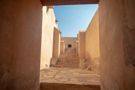 Narrow outdoor staircase in Rustaq Fort, taken on a warm October afternoon, Sultanate of Omanの写真素材