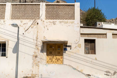 Building entrance and yellow door in the historical district of Muttrah, City of Muscat, Sultanate of Oman.の写真素材