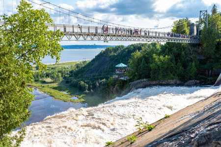 Quebec City, Quebec, Canada - August 7, 2018: Montmorency waterfalls from the top with bridge, visitors and lookoutのeditorial素材