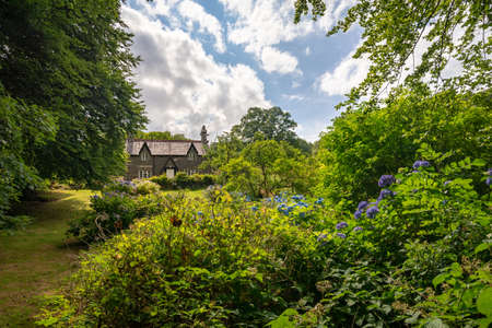Caernarfon, Wales, United Kingdom - July 19, 2018: A small stone cottage hiding in the lush vegetation found near Llyn Gwynant, Walesのeditorial素材