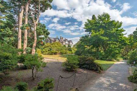 Bodnant Garden, Conwy, Wales, United Kingdom - July 19, 2018: Shade garden, tall trees and a framed view towards Bodnant Hall, Bodnant garden, Conwy, Walesのeditorial素材