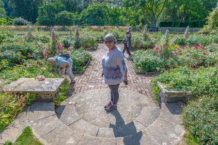 Bodnant Garden, Conwy, Wales, United Kingdom - July 19, 2018: Woman standing in the middle of a circular staircase, Bodnant garden, Conwy, Walesのeditorial素材