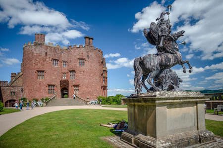 Powis Castle, Powys, Wales, United Kingdom - July 22, 2018: Sculpture and red brick tower, Powis Castle, Powys, Walesのeditorial素材