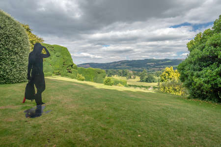 Powis Castle, Powys, Wales, United Kingdom - July 22, 2018: Modern sculpture overlooking the landscape, Powis Castle, Powys, Walesのeditorial素材
