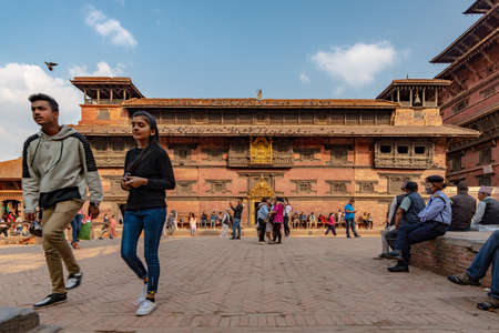 Lalitpur, Patan, Nepal - April  3, 2019: Passersby in front of the main building of the Royal Palace of Patan on the Durbar Square, taken during a partly cloudy afternoonのeditorial素材