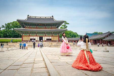 Seoul, South Korea - June 1, 2019: Two women, wearing traditional costume are taking photos for social medias at the Changdeokgung Palaceのeditorial素材