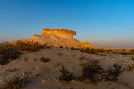 Limestone rock formation in the Qatar desert at sunset