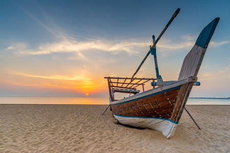 Traditional Arabian boat on a beach. Taken early morning on a beach near Al Wakrah, Qatarの写真素材