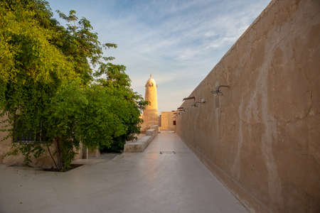 One focal point view of an alley leading to an old mosque and its minaret. Taken early morning in the old souk of Al Wakrah, Qatarの写真素材