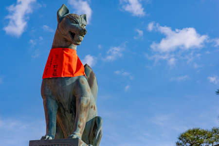 Kyoto, Japan - March 24, 2017: Fox statue at the Fushimi Inari Shrine, taken on a sunny spring afternoon, with sky in the background and with no peopleのeditorial素材