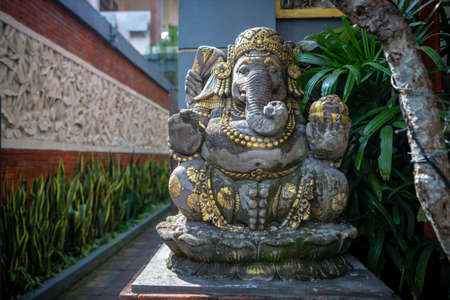 Ganesh statue with golden details, taken on a partly sunny afternoon, Ubud, Bali, Indonesia