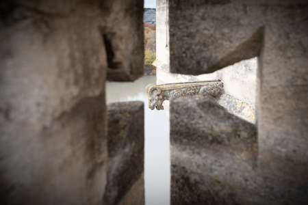 Tarascon, France - Nov 30, 2019: Gargoyle seen through a small arrow slit, Tarascon Castleのeditorial素材
