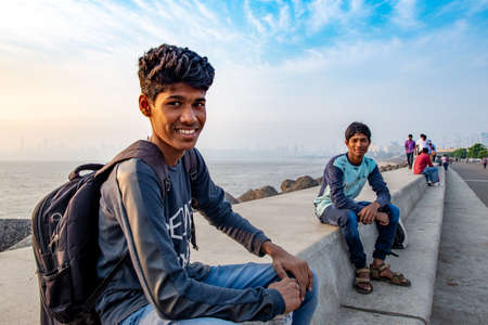 Mumbai, India - December 15, 2017: Young Indian men taking a pose at the camera on Marine Drive,...