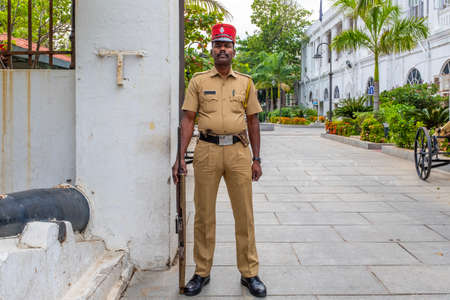 Pondicherry, India - March 17, 2018: Indian policeman dressed as a french gendarme looking at the...