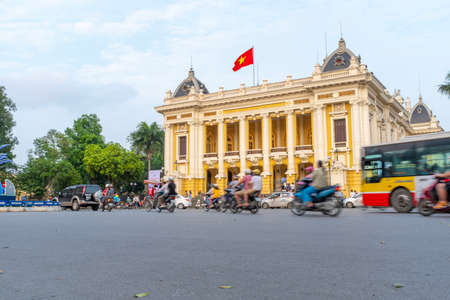 Hanoi, Vietnam - April 30, 2018: Opera house, with traffic on the street and a motorcycle passing in the foregroundのeditorial素材