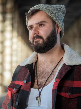 Young french bearded man, taken outside with natural light in Paris, France
