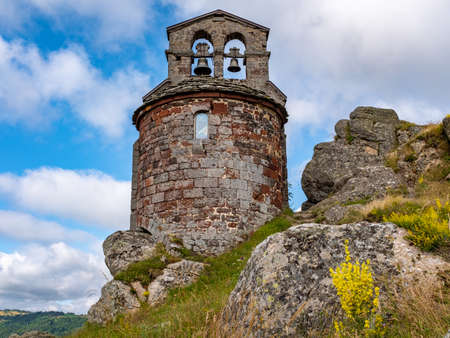 Basaltic stone chapel built on top of a rock formation located along the Way of St. James in central France, taken at the end of a partly overcast afternoon aのeditorial素材