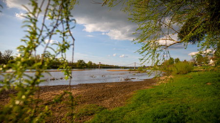 A view on a bridge crossing the Loire River in Cosne-Cours-sur-Loire, taken on a sunny spring day in Burgundy, Franceの写真素材