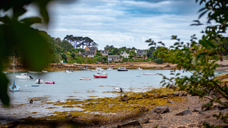 A small harbor seen from the shore, on Brehat Island, taken on an overcast summer morning, Brittany, France.の写真素材