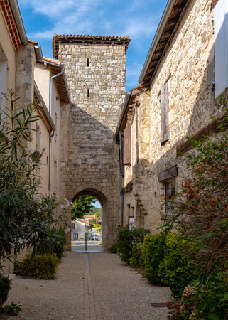 A narrow alley of the medieval town of La Romieu, France, taken on a sunny day with no people.の写真素材