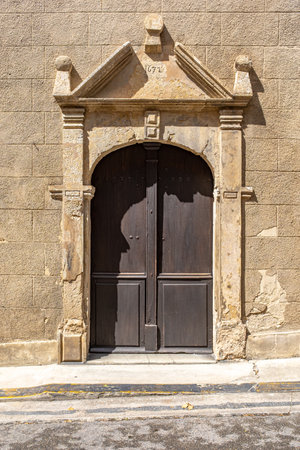One external entrance door of the Condom Cathedral, France, taken on a sunny day with no peopleの写真素材