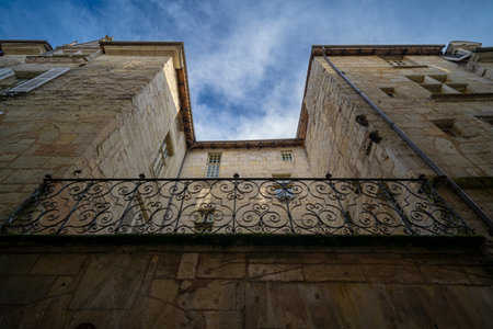 A low-angle photo of a Renaissance limestone townhouse in old Perigueux Dordogne, France. Taken during a sunny autumn day with no peopleの写真素材