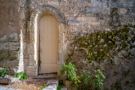 A narrow white door in old Perigueux Dordogne, France. Taken during a sunny autumn day with no peopleの写真素材