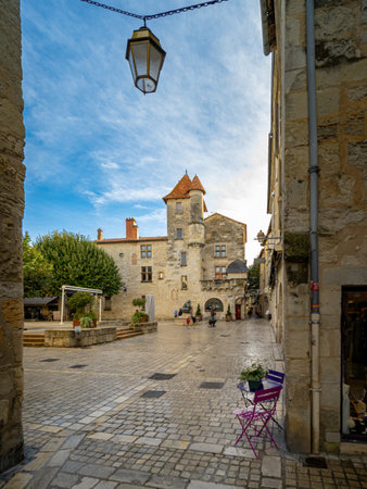 A square in old Perigueux Dordogne, France. Taken during a sunny autumn day with some unrecognizable people in the backgroundの写真素材