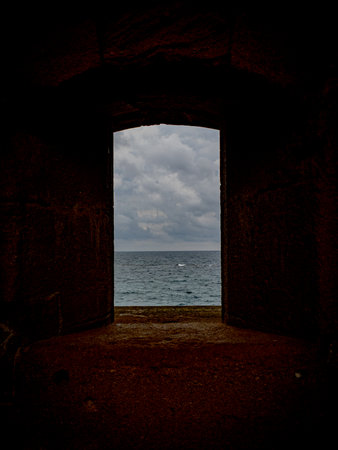 Mediterranean sea seen from a window of the Castello Maniace, Syracuse, Sicily, Italy. Taken under a...