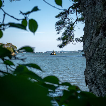 A tree framed view of one island of the bay of Matsushima, Japan, taken on a sunny springtime day with no people.の写真素材