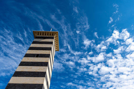 One of the pole marking the entrance of the Deauville harbor, taken at low angle with a blue sky...