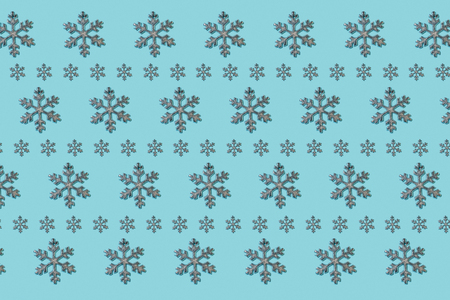 Snowflakes repeated on blue background patternの写真素材