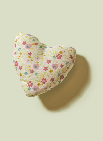 Heart on flowers on yellow background