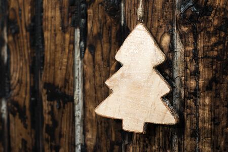 Fir wooden shape on dark brown backgroundの写真素材