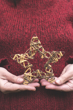Christmas star in hands. Close upの写真素材