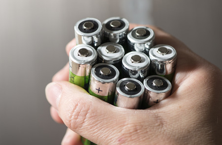 Hand hold many batteries. Close upの写真素材