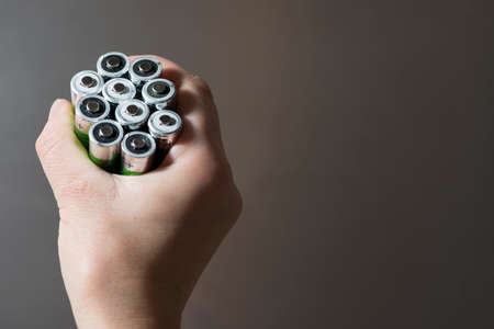 Hand hold many batteries. Close upの写真素材