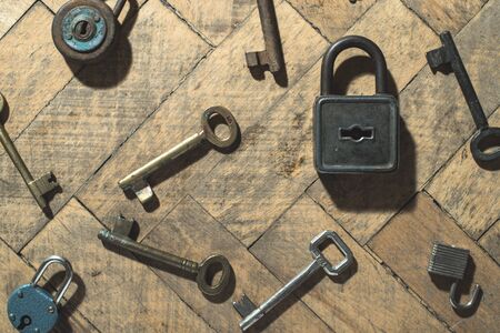 Old padlocks and keys on woodの写真素材
