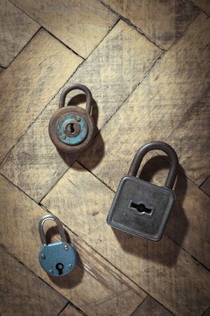 Old padlocks on wood. Vintage rusty padlocks. Close up