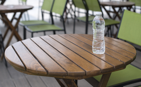 Bottle mineral water on wooden table in restaurant. の写真素材
