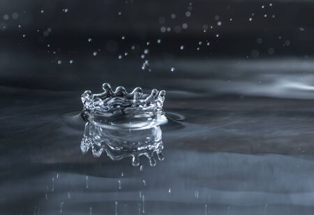 Splashing water drops. Water drop macro shot. Dark background