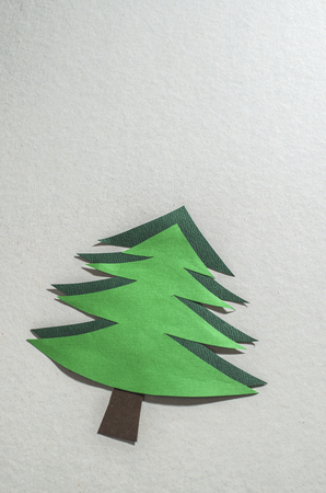 Christmas pine tree made of paper on paper background. Origami christmas treeの写真素材
