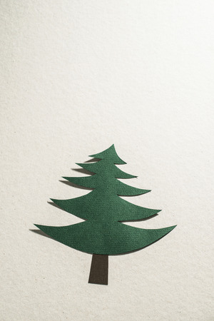 Christmas pine tree made of paper on paper background. Origami christmas treeの写真素材