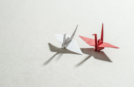 Cranes origami on paper backgroundの写真素材